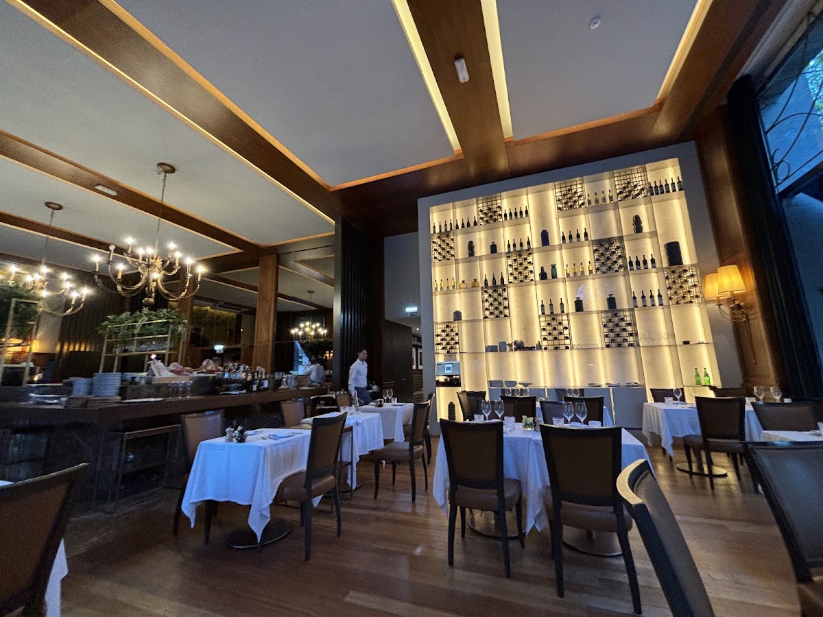 Dining room with an illuminated wall of wine bottles